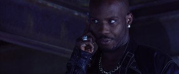 Movie still from “Cradle 2 the Grave” (2003), directed by Andrzej Bartkowiak – A person talking on a cell phone; Close Up shot, Low angle