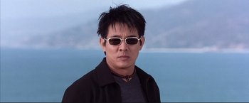 Movie still from “Cradle 2 the Grave” (2003), directed by Andrzej Bartkowiak – A man wearing sunglasses and a black jacket; Close Up shot, Low angle