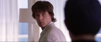 Movie still from “Cradle 2 the Grave” (2003), directed by Andrzej Bartkowiak – A person wearing a white shirt; Close Up shot, Over the shoulder angle