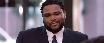 Movie still from “Cradle 2 the Grave” (2003), directed by Andrzej Bartkowiak – A person wearing a suit and tie; Close Up shot, High angle
