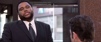 Movie still from “Cradle 2 the Grave” (2003), directed by Andrzej Bartkowiak – A man wearing a suit and tie standing next to another man wearing a suit and tie; Close Up shot, Low angle