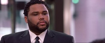 Movie still from “Cradle 2 the Grave” (2003), directed by Andrzej Bartkowiak – A person wearing a suit and tie; Close Up shot, Low angle