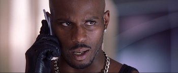 Movie still from “Cradle 2 the Grave” (2003), directed by Andrzej Bartkowiak – A person with a cell phone; Close Up shot, Low angle