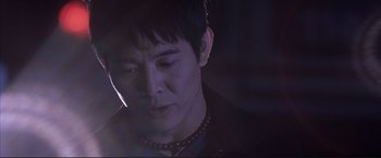 Movie still from “Cradle 2 the Grave” (2003), directed by Andrzej Bartkowiak – A person wearing a necklace; Close Up shot, Low angle