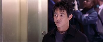 Movie still from “Cradle 2 the Grave” (2003), directed by Andrzej Bartkowiak – A person wearing a black jacket; Close Up shot, Over the shoulder angle