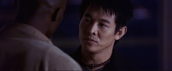 Movie still from “Cradle 2 the Grave” (2003), directed by Andrzej Bartkowiak – A person wearing a necklace; Close Up shot, Over the shoulder angle