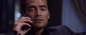 Movie still from “Cradle 2 the Grave” (2003), directed by Andrzej Bartkowiak – A person talking on a cell phone; Close Up shot, Low angle