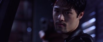 Movie still from “Cradle 2 the Grave” (2003), directed by Andrzej Bartkowiak – A person holding a gun; Close Up shot, Low angle