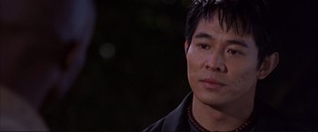 Movie still from “Cradle 2 the Grave” (2003), directed by Andrzej Bartkowiak – A person wearing a black shirt; Close Up shot, Over the shoulder angle