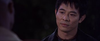 Movie still from “Cradle 2 the Grave” (2003), directed by Andrzej Bartkowiak – A person wearing a black jacket; Close Up shot, Over the shoulder angle