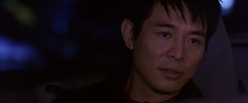 Movie still from “Cradle 2 the Grave” (2003), directed by Andrzej Bartkowiak – A man's face in the dark; Close Up shot, Over the shoulder angle