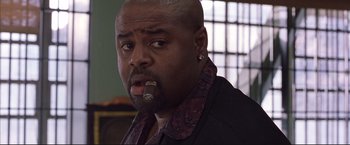 Movie still from “Cradle 2 the Grave” (2003), directed by Andrzej Bartkowiak – A man with a cigarette in his mouth; Close Up shot, Low angle