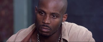 Movie still from “Cradle 2 the Grave” (2003), directed by Andrzej Bartkowiak – A person wearing a shirt; Close Up shot, High angle