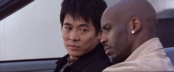 Movie still from “Cradle 2 the Grave” (2003), directed by Andrzej Bartkowiak – A man and a man sitting next to each other; Close Up shot, Low angle