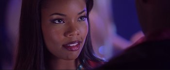 Movie still from “Cradle 2 the Grave” (2003), directed by Andrzej Bartkowiak – A woman's face in a dark room; Close Up shot, Over the shoulder angle