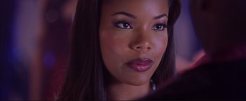 Movie still from “Cradle 2 the Grave” (2003), directed by Andrzej Bartkowiak – A woman's face in a dark room; Close Up shot, Over the shoulder angle