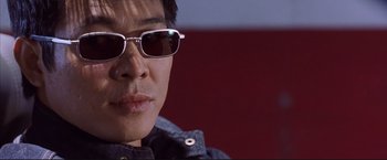 Movie still from “Cradle 2 the Grave” (2003), directed by Andrzej Bartkowiak – A person wearing sunglasses; Close Up shot, Low angle