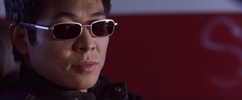 Movie still from “Cradle 2 the Grave” (2003), directed by Andrzej Bartkowiak – A person wearing sunglasses; Close Up shot, Low angle