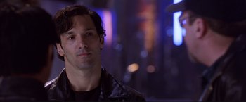 Movie still from “Cradle 2 the Grave” (2003), directed by Andrzej Bartkowiak – A person wearing a leather jacket; Close Up shot, Over the shoulder angle