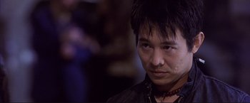 Movie still from “Cradle 2 the Grave” (2003), directed by Andrzej Bartkowiak – A person wearing a black shirt; Close Up shot, Low angle