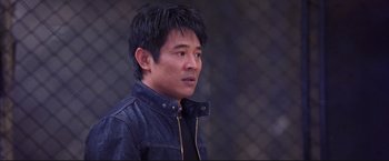 Movie still from “Cradle 2 the Grave” (2003), directed by Andrzej Bartkowiak – A man in a black shirt and a black jacket; Medium shot, Over the shoulder angle