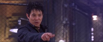 Movie still from “Cradle 2 the Grave” (2003), directed by Andrzej Bartkowiak – A man in a black jacket pointing to the side; Close Up shot, Low angle