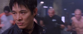 Movie still from “Cradle 2 the Grave” (2003), directed by Andrzej Bartkowiak – A person wearing a black jacket; Close Up shot, Low angle
