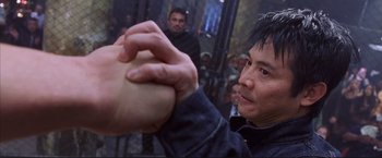 Movie still from “Cradle 2 the Grave” (2003), directed by Andrzej Bartkowiak – A man holding a ball in his hands; Close Up shot, Low angle