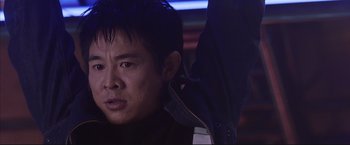 Movie still from “Cradle 2 the Grave” (2003), directed by Andrzej Bartkowiak – A person wearing a black jacket; Close Up shot, Low angle