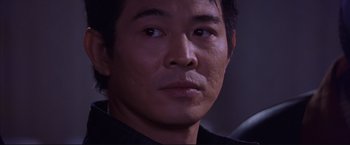 Movie still from “Cradle 2 the Grave” (2003), directed by Andrzej Bartkowiak – A man's face in a dark room; Close Up shot, Over the shoulder angle