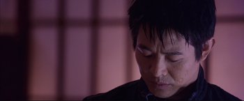 Movie still from “Cradle 2 the Grave” (2003), directed by Andrzej Bartkowiak – A person looking down at his face; Close Up shot, Low angle