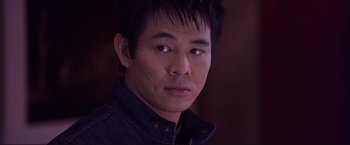 Movie still from “Cradle 2 the Grave” (2003), directed by Andrzej Bartkowiak – A person wearing a jean jacket; Close Up shot, Low angle