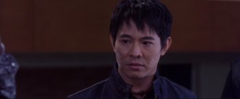 Movie still from “Cradle 2 the Grave” (2003), directed by Andrzej Bartkowiak – A person wearing a black jacket; Close Up shot, Low angle