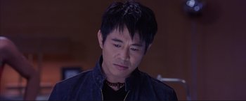 Movie still from “Cradle 2 the Grave” (2003), directed by Andrzej Bartkowiak – A person wearing a black shirt; Close Up shot, High angle