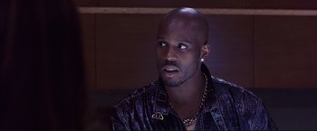 Movie still from “Cradle 2 the Grave” (2003), directed by Andrzej Bartkowiak – A person wearing a leather jacket; Close Up shot, Low angle