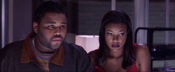 Movie still from “Cradle 2 the Grave” (2003), directed by Andrzej Bartkowiak – A man and a woman sitting next to each other; Close Up shot, Low angle