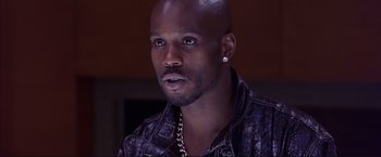 Movie still from “Cradle 2 the Grave” (2003), directed by Andrzej Bartkowiak – A person wearing a leather jacket; Close Up shot, High angle