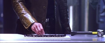 Movie still from “Cradle 2 the Grave” (2003), directed by Andrzej Bartkowiak – A person is typing on a computer keyboard; Extreme Close Up shot, High angle