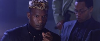 Movie still from “Cradle 2 the Grave” (2003), directed by Andrzej Bartkowiak – A person wearing a hat; Close Up shot, Low angle