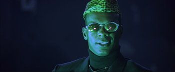 Movie still from “Cradle 2 the Grave” (2003), directed by Andrzej Bartkowiak – A man wearing a hat and sunglasses in the dark; Close Up shot, Low angle