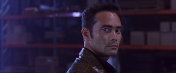 Movie still from “Cradle 2 the Grave” (2003), directed by Andrzej Bartkowiak – A person wearing a leather jacket; Close Up shot, Low angle