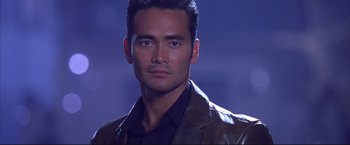 Movie still from “Cradle 2 the Grave” (2003), directed by Andrzej Bartkowiak – A person wearing a suit and tie; Close Up shot, Low angle