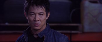 Movie still from “Cradle 2 the Grave” (2003), directed by Andrzej Bartkowiak – A person wearing a black shirt; Close Up shot, Low angle