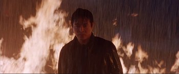 Movie still from “Cradle 2 the Grave” (2003), directed by Andrzej Bartkowiak – A man standing in front of a wall of fire; Close Up shot, Low angle