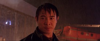 Movie still from “Cradle 2 the Grave” (2003), directed by Andrzej Bartkowiak – A person wearing a jacket in the rain; Close Up shot, Low angle