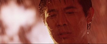 Movie still from “Cradle 2 the Grave” (2003), directed by Andrzej Bartkowiak – A man's face in the rain; Extreme Close Up shot, Low angle
