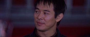 Movie still from “Cradle 2 the Grave” (2003), directed by Andrzej Bartkowiak – A person wearing a black jacket; Close Up shot, Low angle