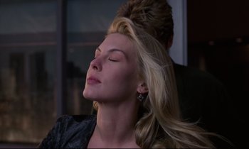 Movie still from “Crash” (1996), directed by David Cronenberg – A woman with her eyes closed with her hair blowing in the wind; Close Up shot, Low angle