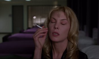 Movie still from “Crash” (1996), directed by David Cronenberg – A beautiful woman holding a cigarette in her mouth; Close Up shot, Low angle