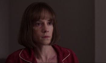 Movie still from “Crash” (1996), directed by David Cronenberg – A woman in a red shirt is looking at the camera; Close Up shot, Over the shoulder angle